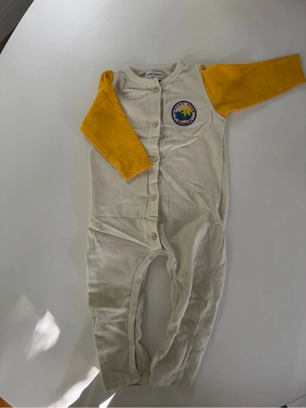 Bobo Choses Cream Footie with Yellow Sleeves and Chest Patch